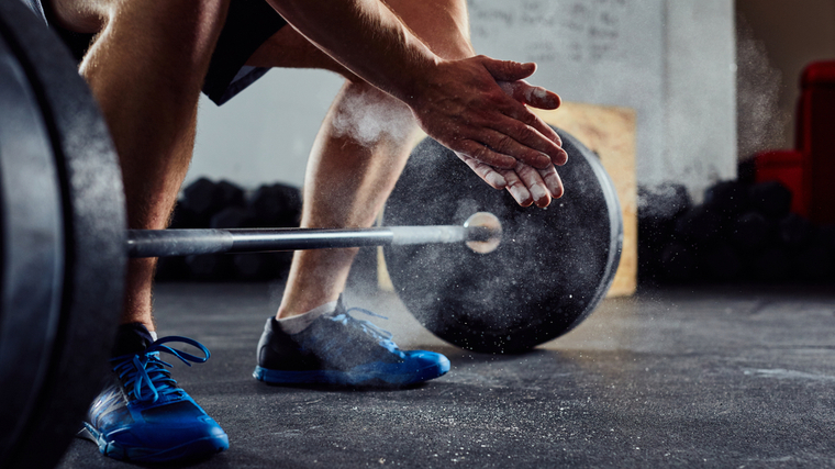 weightlifter chalking up for snatch 