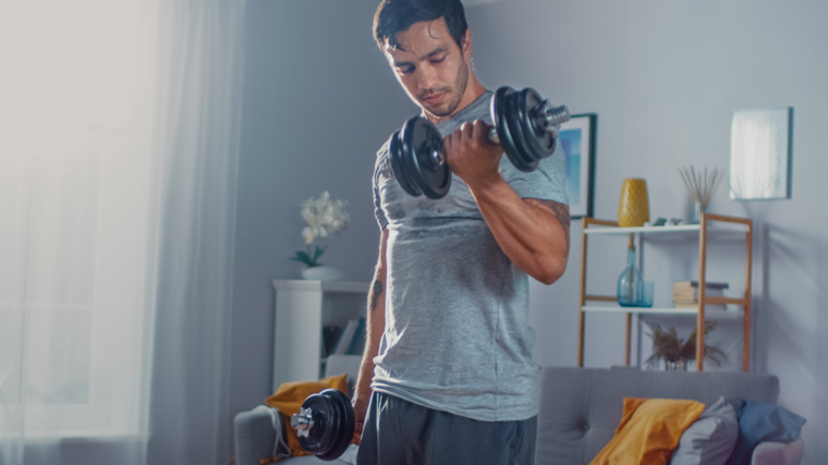 man doing dumbbell curl at home