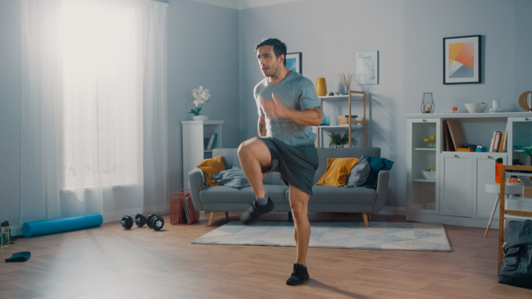 man doing high knees at home 