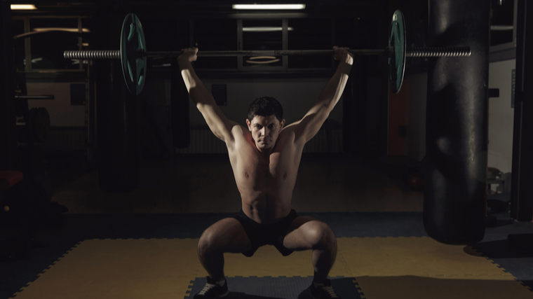 A person performs a snatch.