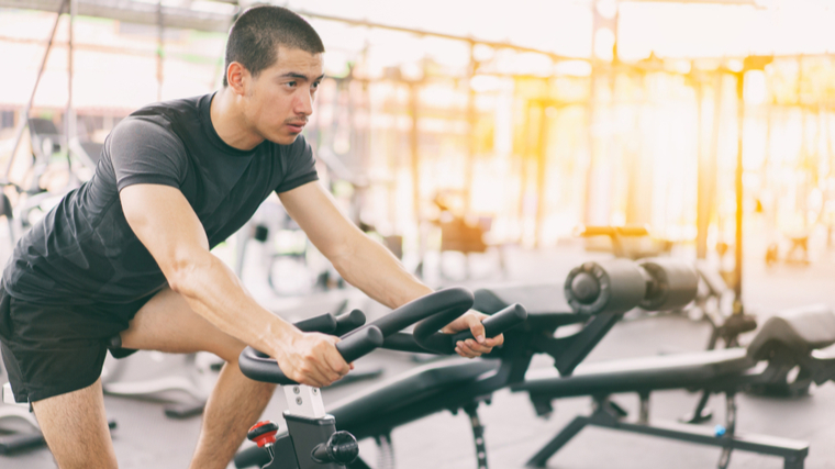 man cycling in gym