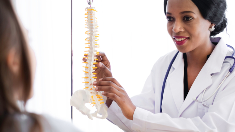 A doctor explains the spine to their patient.