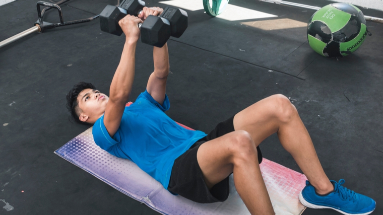 A person performs a floor press.