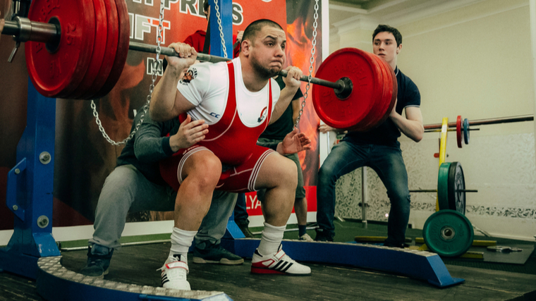 man performing powerlifting squat