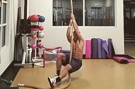 Premium Photo  Sportsman doing rope climbing exercise