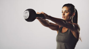 Woman swinging kettlebell