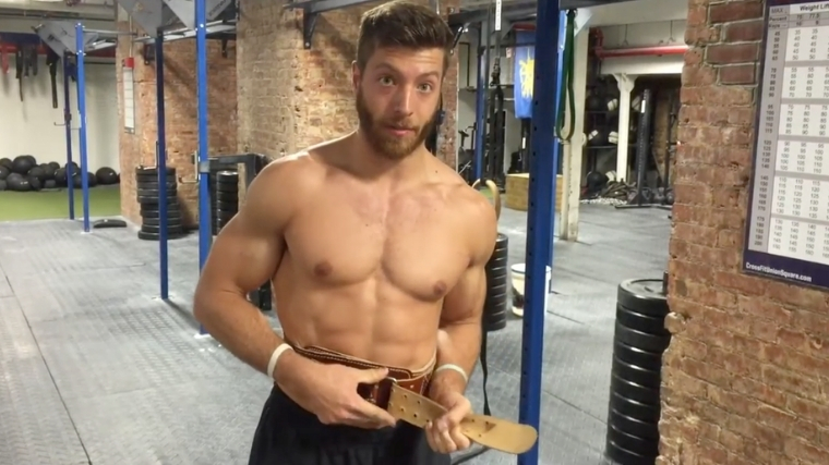 Man securing weightlifting belt