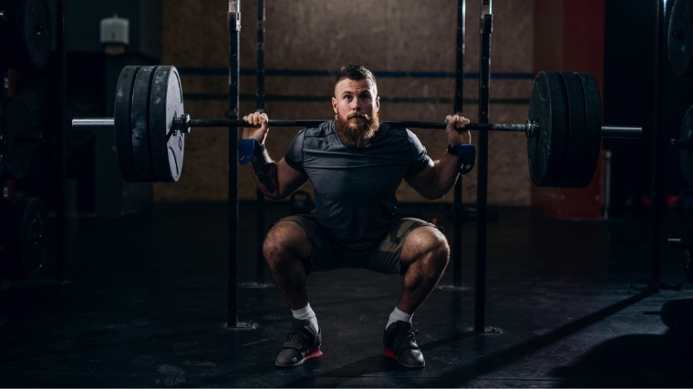 Man performing back squat