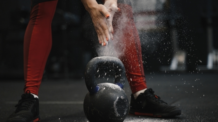 Woman about to lift kettlebell