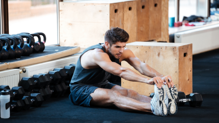 man testing hamstring flexibility