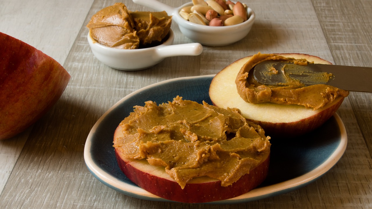 Peanut butter slathered on an apple slice