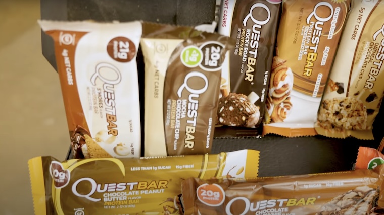 Several Quest Protein Bars displayed in the BarBend testing facility.