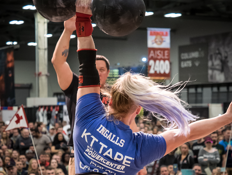 woman circus dumbbell overhead arnold