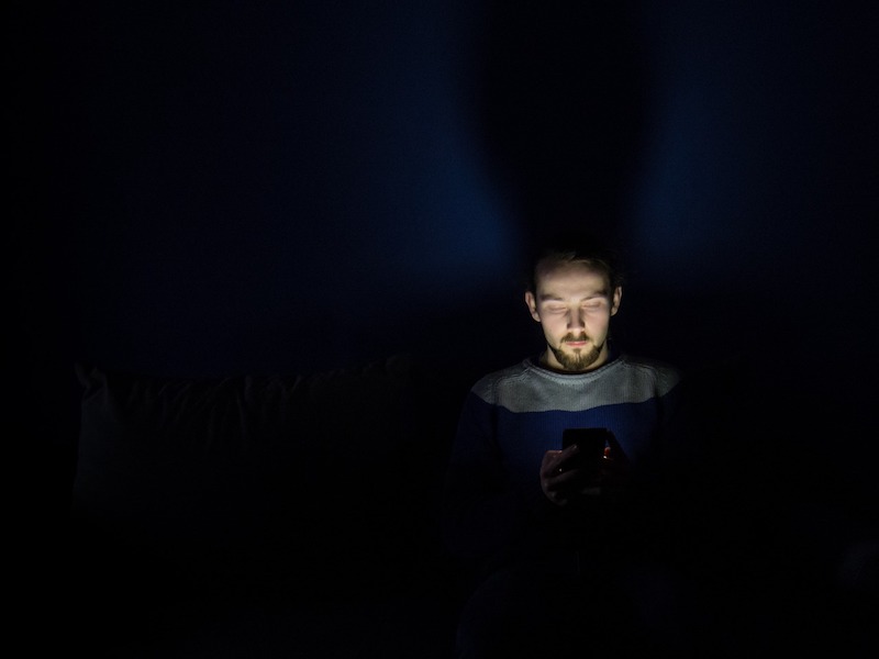 guy in bed with phone