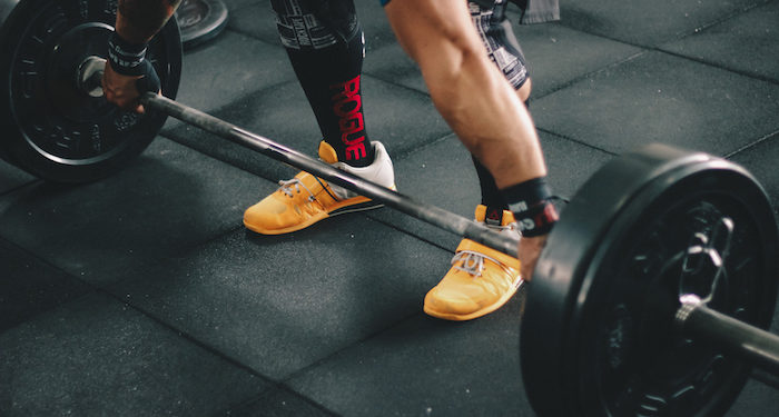 person about to lift barbell free