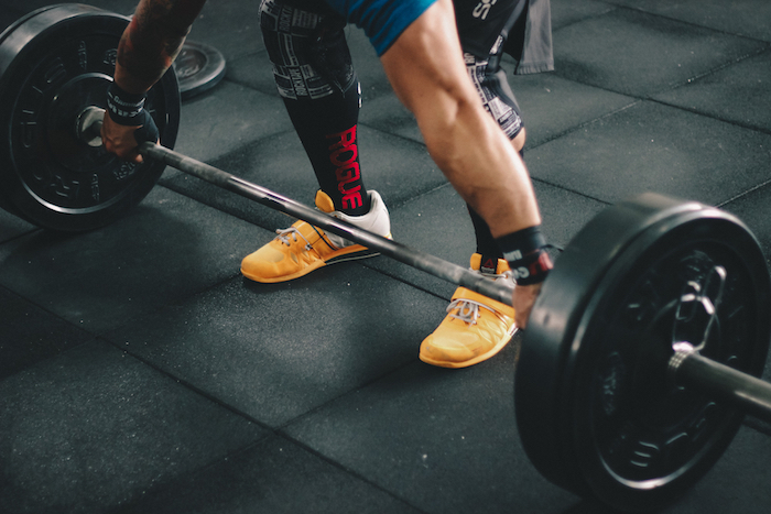 person about to lift barbell free