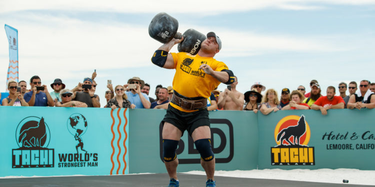 Athletes compete in overhead press in the 2019 42nd World's Strongest Man Competition on Coquina Beach in Bradenton, Fla., on Friday, June 14, 2019. /