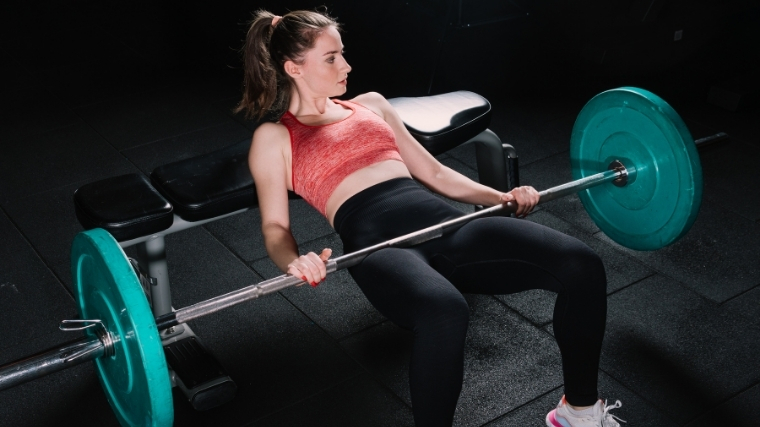 Woman doing barbell hip thrust