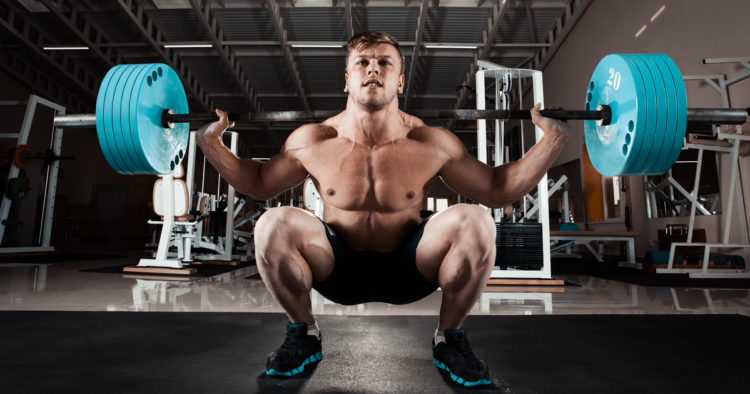 Athlete bracing his core during a squat