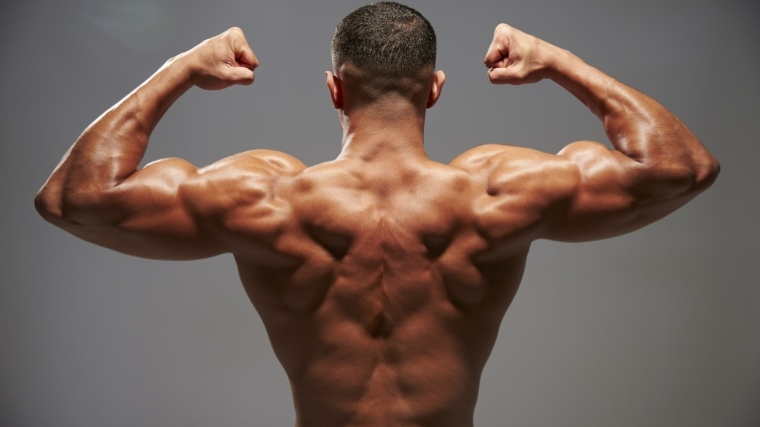 man flexing back muscles