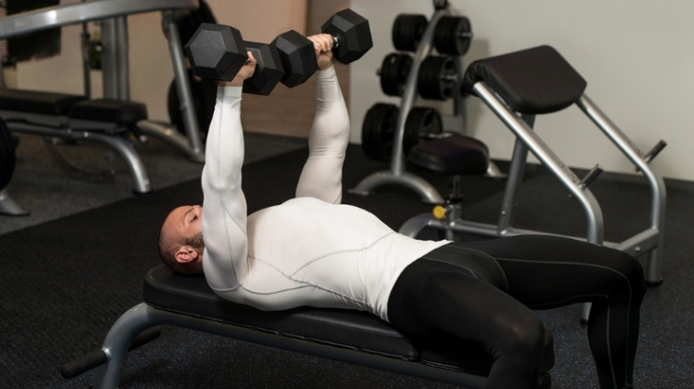 Man doing dumbbell chest press