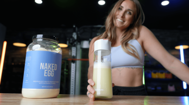 a woman mixing up naked nutrition naked egg protein powder