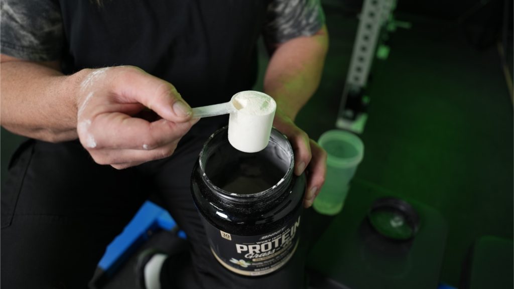 Our tester scooping Onnit Whey Protein.