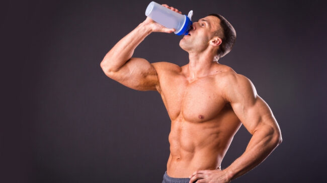 Man drinking from shaker bottle