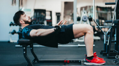 A person performs a barbell hip thrust.