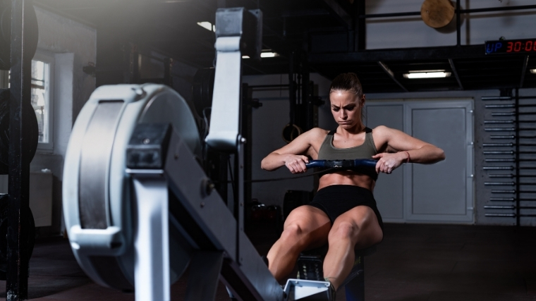 Woman rowing on an erg