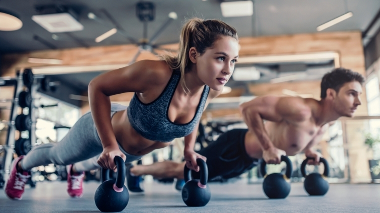 man and woman doing push-ups