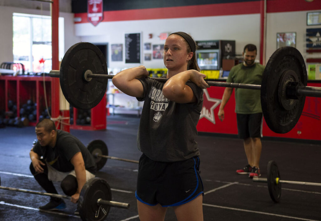 A CrossFit athlete cleaning