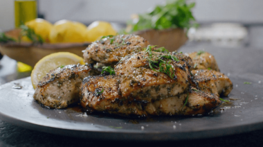 a plate of seasoned chicken with herbs