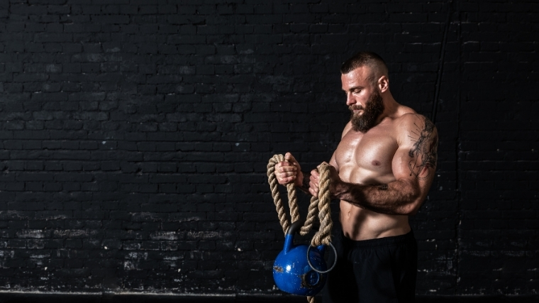 Man doing kettlebell curls