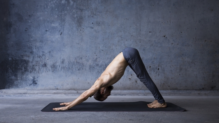 Man doing downward dog pose