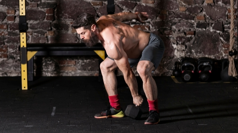 Man doing a dumbbell snatch