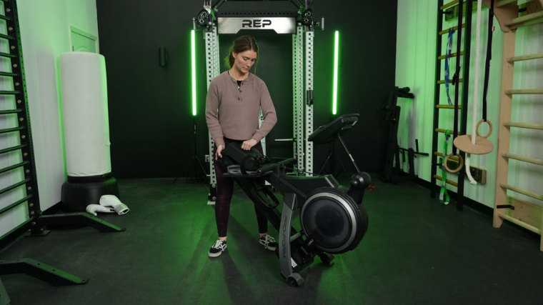 A person folding up the ProForm 750R rowing machine. 