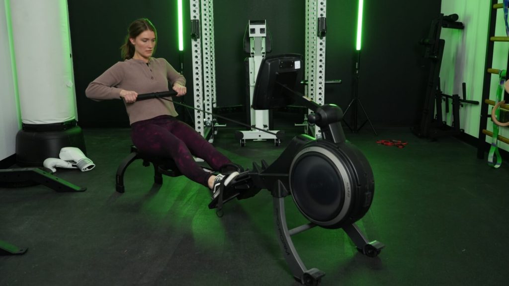 A BarBend tester rowing on the ProForm 750R.