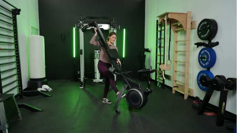 A person unfolding the ProForm 750R rowing machine.