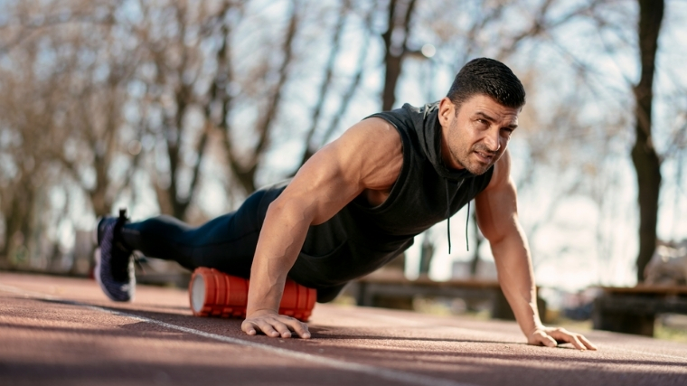 Man foam rolling quads