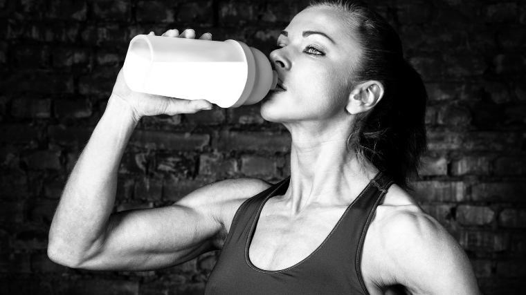 Woman drinking pre-workout
