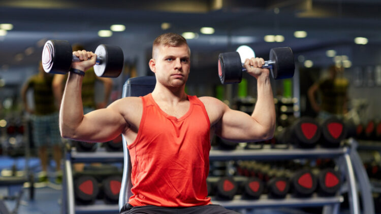 Man performing seated shoulder dumbbell press