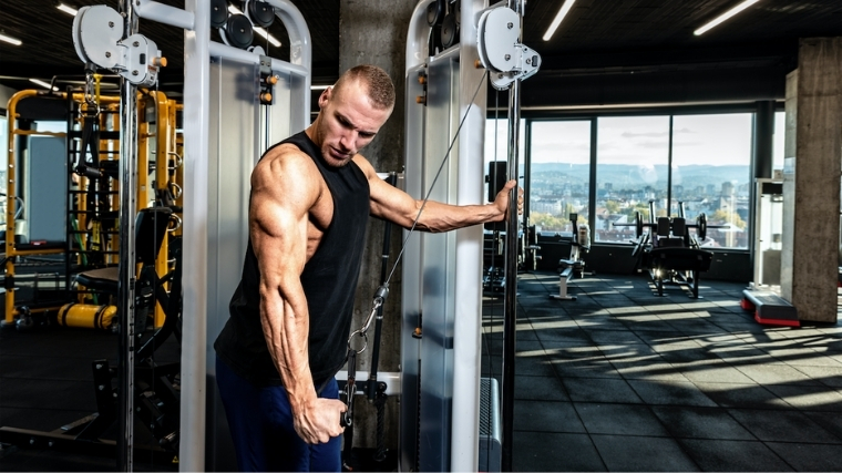 Man performing triceps pushdown