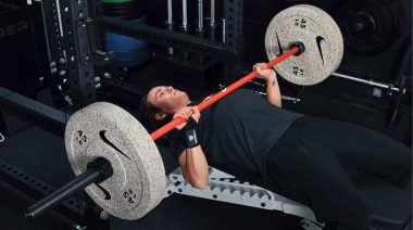 A person doing the bench press, following one of the bench press programs.