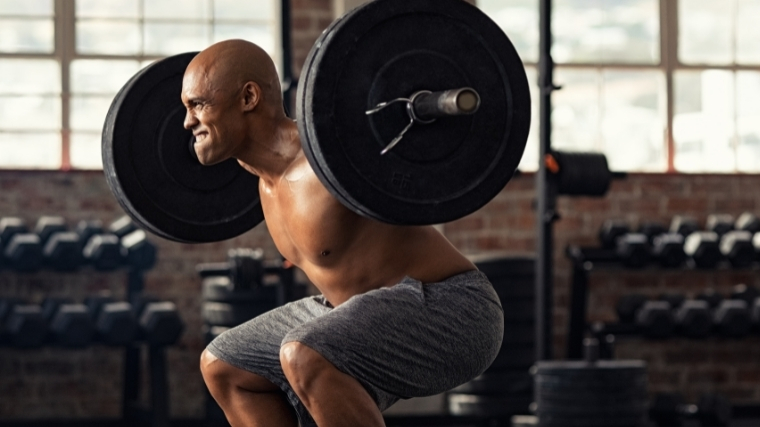 Man performing barbell back squat