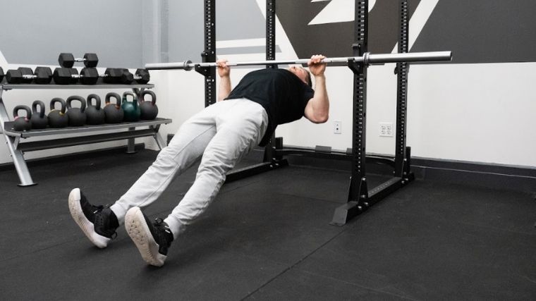 Man performing inverted row exercise