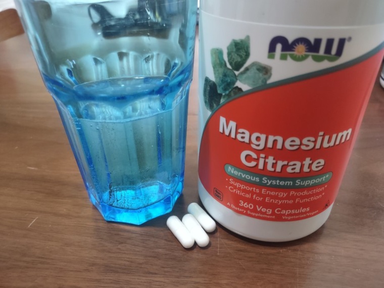 NOW Foods Magnesium Citrate with a glass of water.