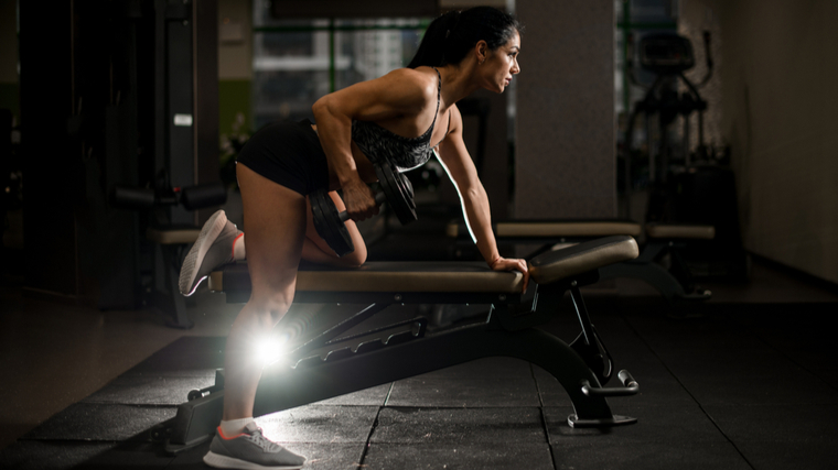 woman doing dumbbell row 