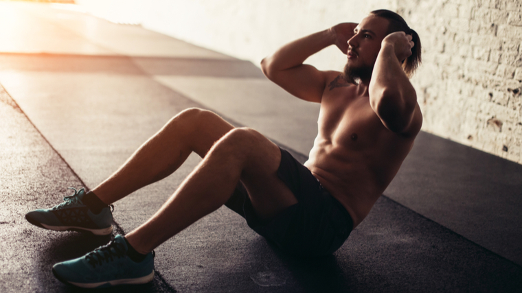 shirtless guy doing crunch 