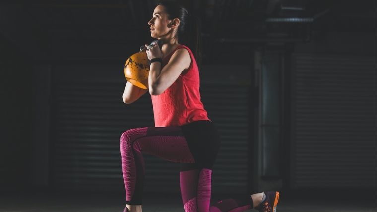 Woman doing kettlebell lunge